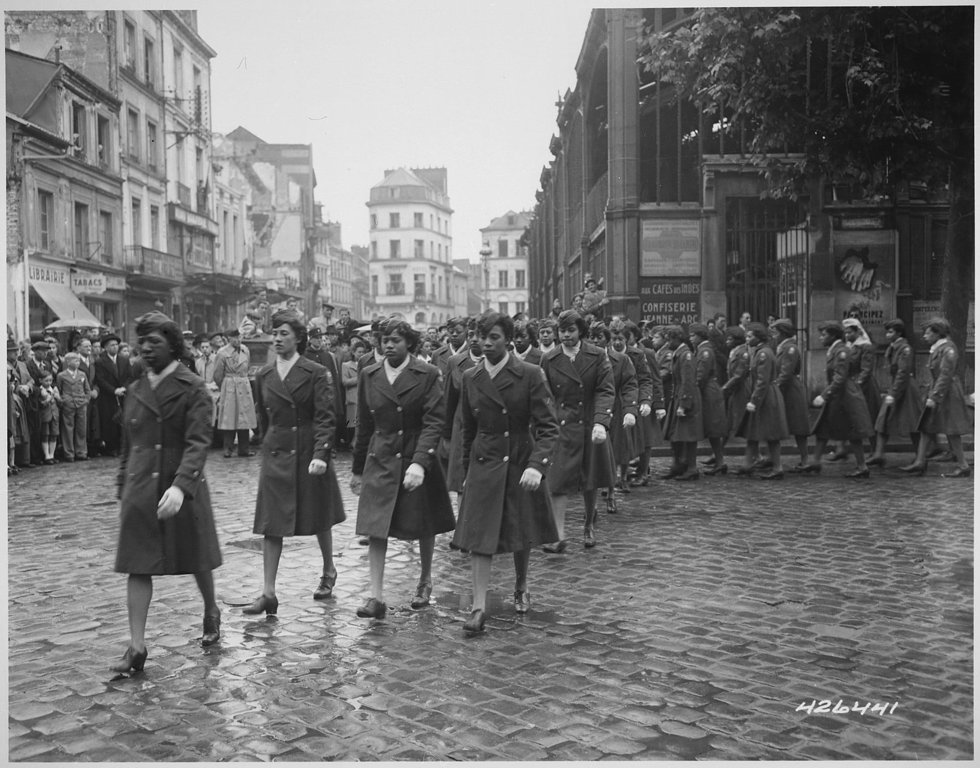 Black women in WW2 army uniforms marching in Paris